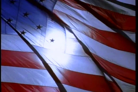 American Flag slow motion back lighting sun behind Stock Footage 179653757