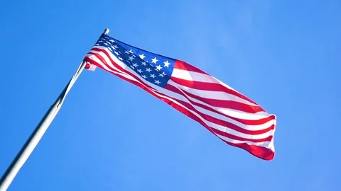 American Flag Slow Motion Blowing in Wind Blue Sky Stock Footage 100272799