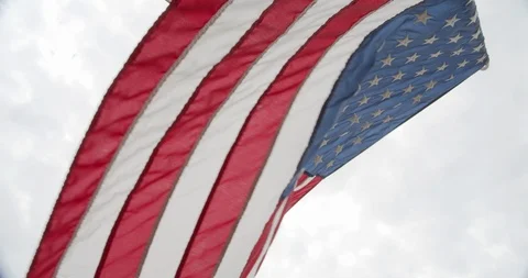 American Flag in Slow Motion on Cloudy Sky Stock Footage 105294256