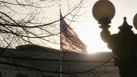 American Flag Slow Motion Sunset Silhouette Blowing in Wind Pan Right Video stock 125519534