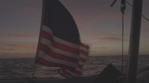 American flag in the sunset on a sailboat Stock Footage 236484401