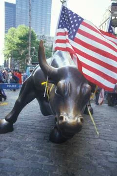 American Flag Tied to Sculpture of Bull, Wall Street, New York City, New York Stock Photos