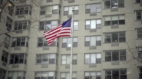 American flag tilting down to residential building entrance taxi cab driving NYC Stock Footage 71264264