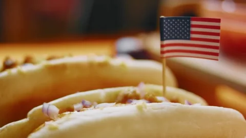 American flag toothpick standing in a loaded hot dog, macro flag detail, 4K Stock Footage 341122374