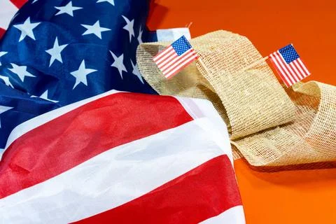American flag with two other small ones on an orange background American f... Stock Photos