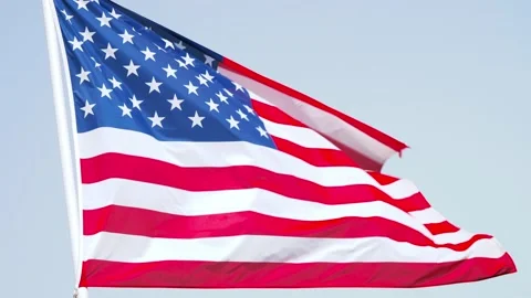 American flag wave in the wind on flagpole against the sky. close-up of USA flag Stock Footage 201485627
