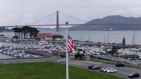 American flag waves above marina filled with sailboats and yachts, Golden Gate Stock Footage 337745991