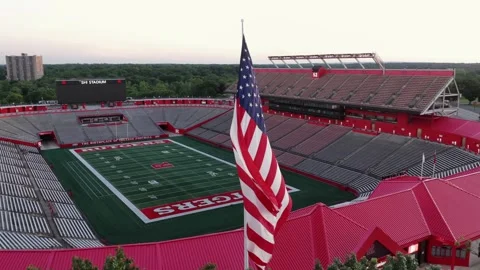 American flag waves before empty SHI Stadium seating at Rutgers University in Stock Footage 340856916