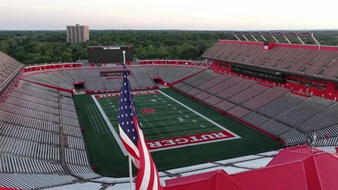 American flag waves in foreground of empty SHI Stadium at Rutgers University in Stock Footage 340969575