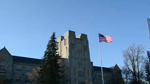 American Flag waves in front of college lecture hall Video stock 53000680