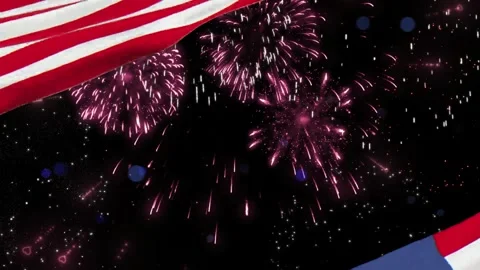 An american flag waves gently while colorful fireworks explode in the night sky Video stock 340942139