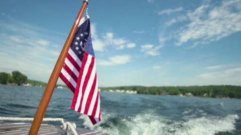 American flag waves in slow motion on the back of a motor boat Stock Footage 130338072