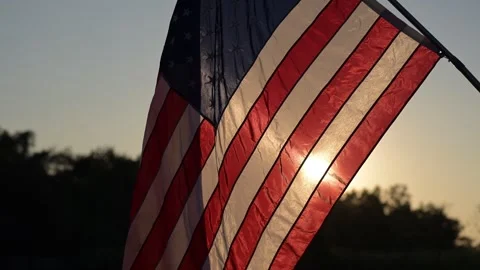 American Flag Waves at Sunset in Nature Symbolizing Freedom and Unity Vibrant Stock Footage 296668296