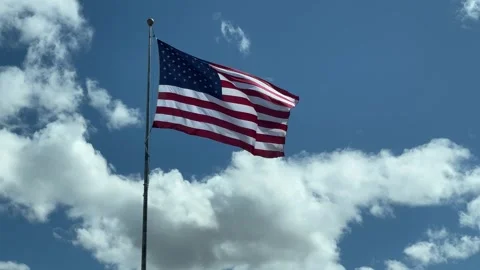 American Flag waving in the clouds Stock Footage 242385090