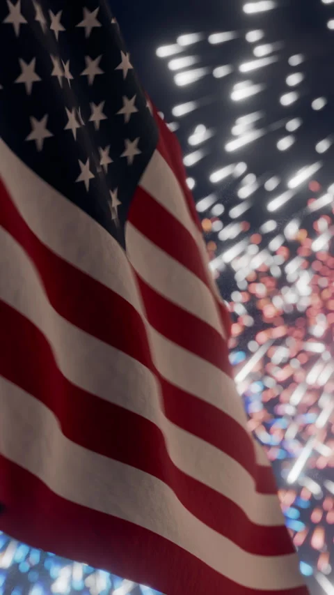 American flag waving in the night sky amidst exploding fireworks 스톡 동영상 339010409