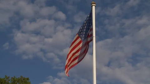 American Flag waving over blue sky Stock Footage 46422487