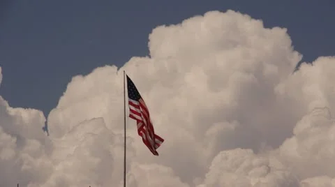 American Flag waving with puffy clouds in background timelapse.m Stock Footage 18938798