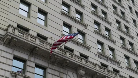 American Flag Waving from Stone Facade of a Historical Urban Architecture Stockbeeldmateriaal 330987517
