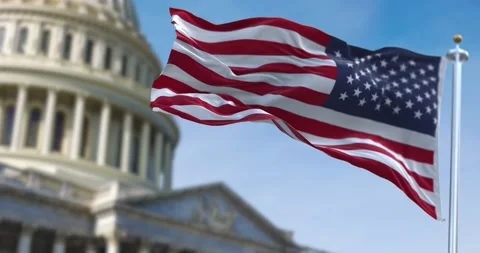 American flag waving with the US Capitol Hill blurred in the background 库存影片 148304746