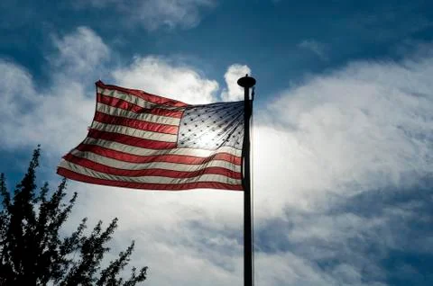 American flag waving while back lit Stock Photos