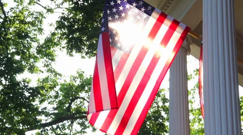 American flag waving in wind back lit by the sun 스톡 동영상 39818268