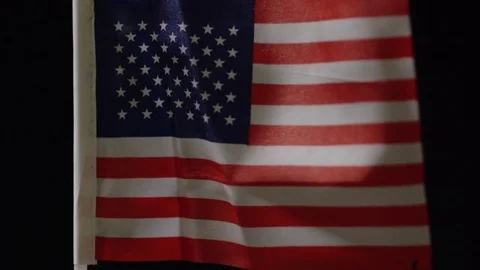 American flag waving in the wind on black background Video stock 85332073