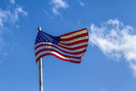 American flag waving in the wind. Stock Photos