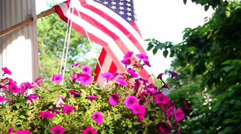 American flag waving in the wind on a porch Stock Footage