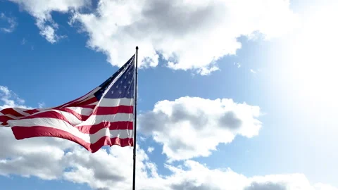American Flag Waving in Wind with Slow Moving Orbiting Camera and Cloudy Sky Stock Footage 333797632