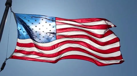 American flag waving in wind with sun backlight Stock Footage 51150153