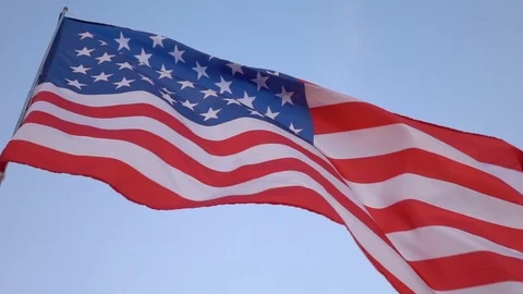 American flag in the wind on blue sky, slow motion Stock Footage 77012164