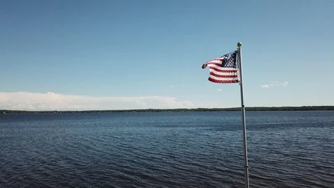 American Flag in the Wind on a Lake Stock Footage 99065042