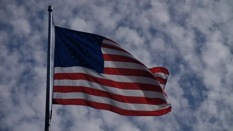 American Flag in the Wind Slow Motion Blue Sky 4K 24p Stock Footage 87538460