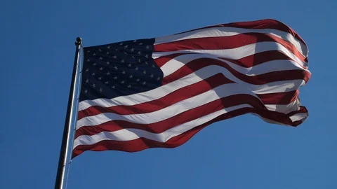 American Flag in the Wind Slow Motion Blue Sky HD 24P Stock Footage 87539355