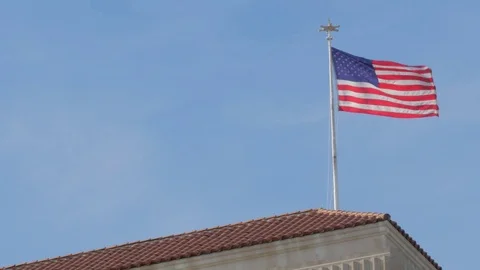 American Flag in the Wind on The Top of U.S. Embassy Building  Stock Footage 83116364