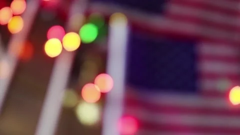 American flags and glowing light christmas blurred background panning shot Stock Footage 117473667