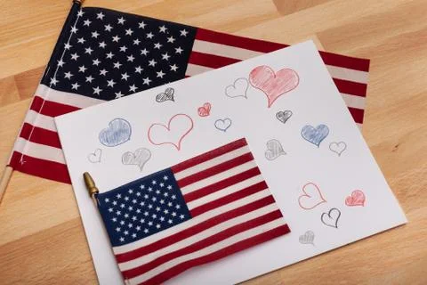 American flags with assorted hand-drawn hearts on paper background Stock Photos