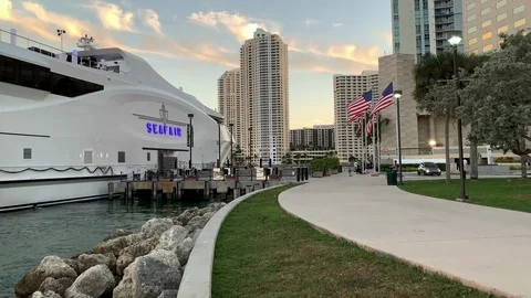 American Flags on Buildings Background. Downtown Miami. Famous district Bayside Stock Footage 100713115
