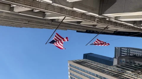 American flags hang from facade of building in New York City. Lower Manhattan Stock Footage 169530839