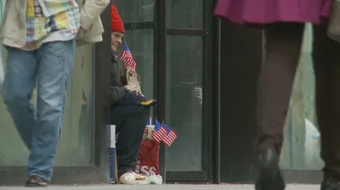 American flags held by homeless man (street life) Stock Footage 7727102