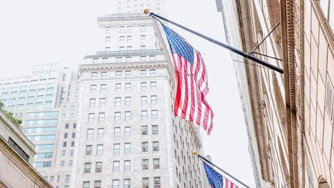 American flags on the main facade of the New York Stock Exchange - NYSE Building Stock Photos
