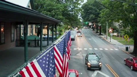 American flags in small town in USA. Summer establishing shot of holiday Stock Footage 162095546