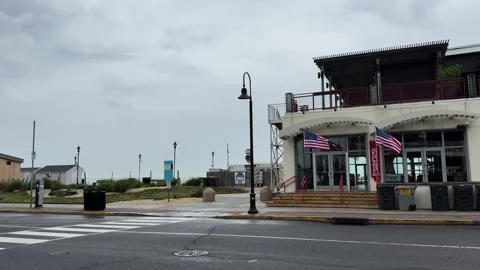 American Flags Wave Before Asbury Park Boardwalk Building Stock Footage 336701436