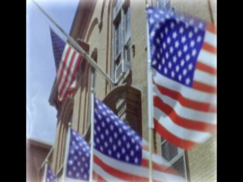 American flags waving on the building in New York City. 8mm film footage. Vídeo Stock 75213161