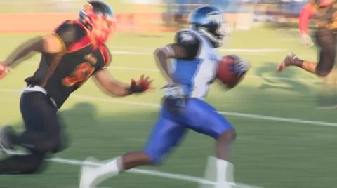 American football back runs ball and tackled slow motion Stock Footage