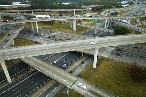 American freeway intersection with fast driving cars and trucks. View from above Stock Photos