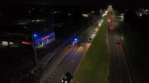 American intersection with police car during police check of public car. Night Stock Footage 312804105