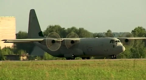 American Lockheed C-130 Hercules military transport aircraft moves along runway. Video stock 172486890