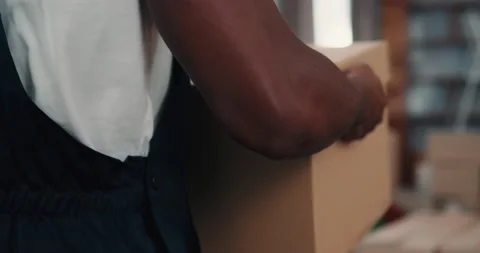 American Man Courier Delivering Boxes for Young Couple in New Apartment. Man Stock Footage 172080495
