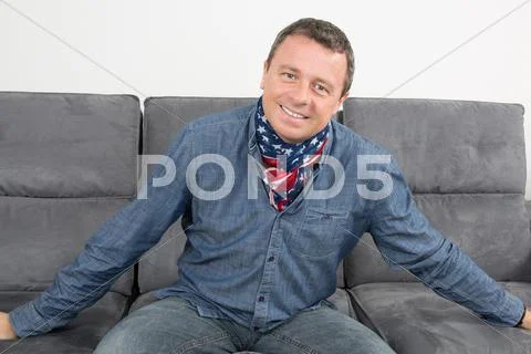 American Man With A Scarf On The Sofa Casual Clothes